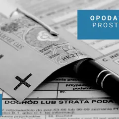 Złoty banknot 100 zł, długopis i formularz podatkowy.