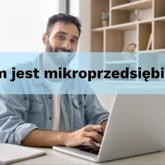 Uśmiechnięty mężczyzna pracuje przy laptopie. Kim jest mikroprzedsiębiorca?