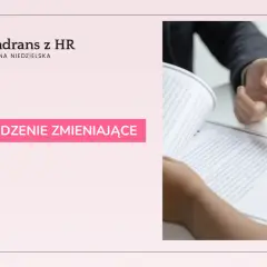 Dwie osoby przy stole przeglądają dokument, jedna wskazuje palcem na tekst.