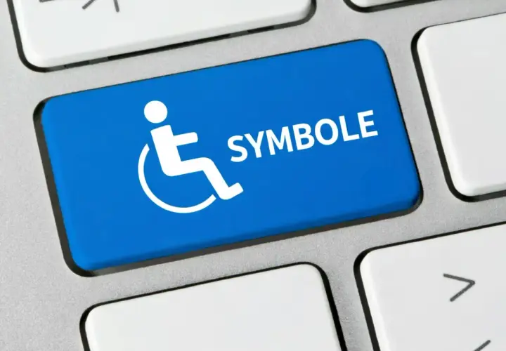 Niebieski klawisz z białym symbolem niepełnosprawności i napisem "SYMBOLE".