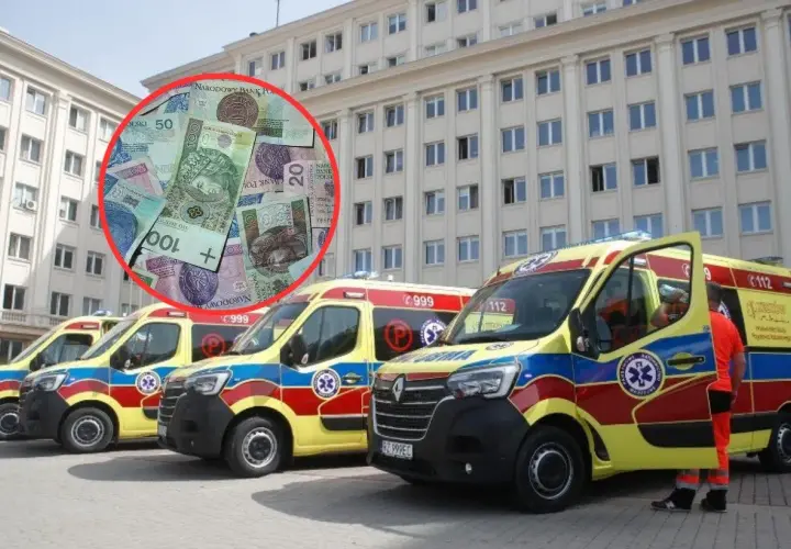 Polskie banknoty w czerwonym okręgu na tle kilku karetek pogotowia przed budynkiem.